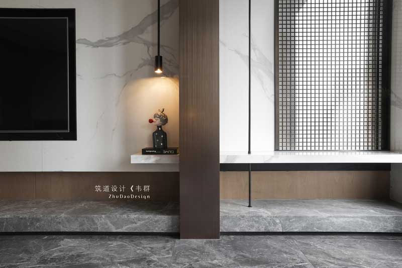 原本木飾面這塊是承重柱，為了弱化它的存在感，設計師通過穿插的手法，將線條穿插過來，空間有了靈動性，不會顯得呆板。